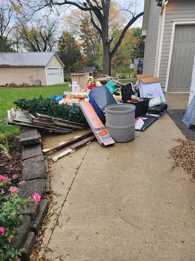 Dumpster being loaded with debris for 3 Yard Dumpster Rental in Weaverville